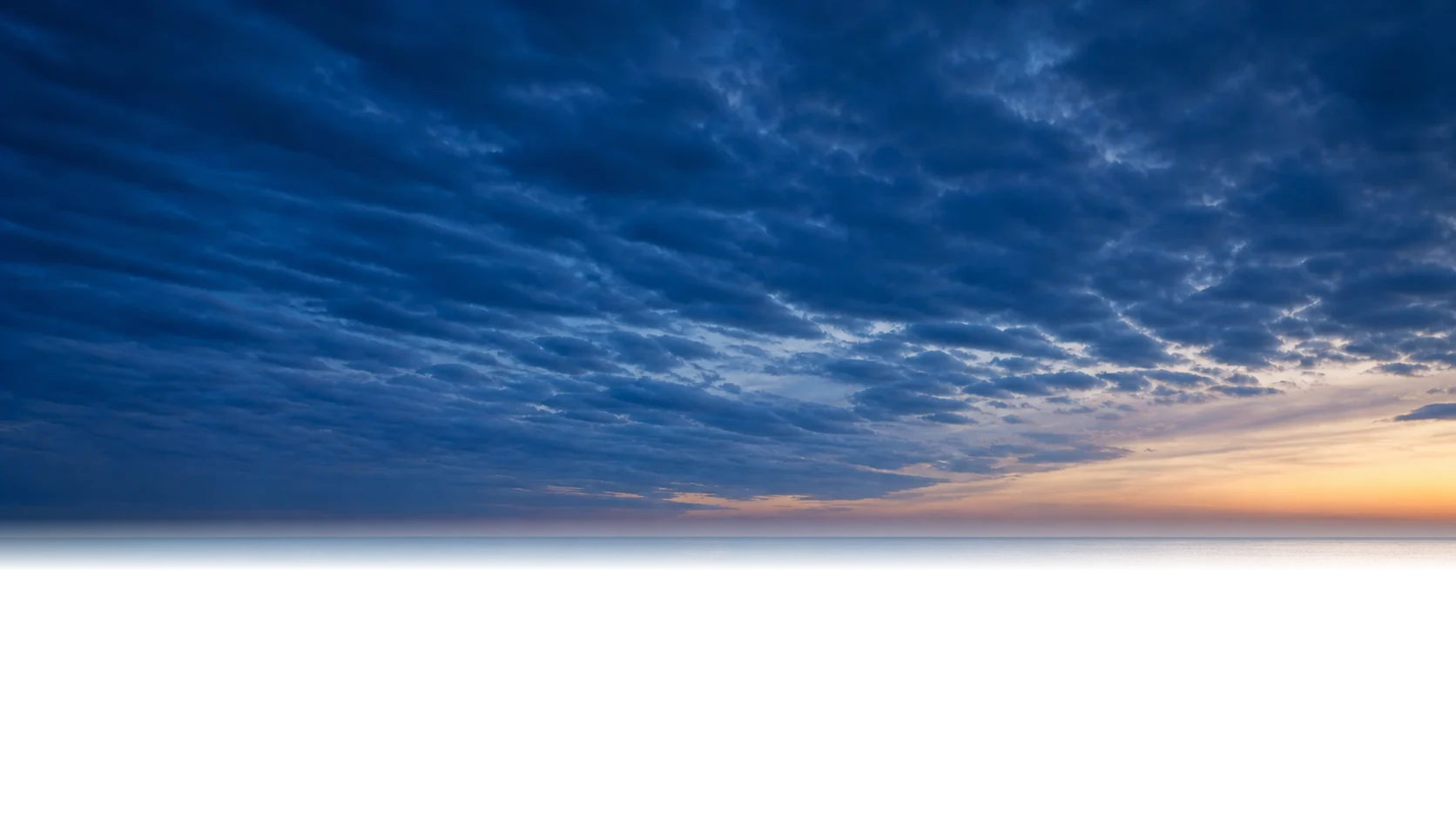 Lake Erie at blue hour with the Cleveland skyline in the distance